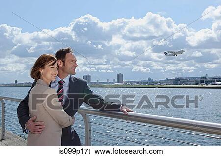 Stock Photograph - Mid adult couple outside airport. Fotosearch