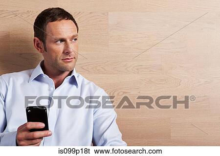Mid adult man texting, portrait View Large Photo Image Stock Photograph - Mid adult man texting, portrait. Fotosearch