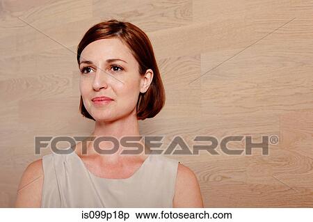 Stock Photography - Mid adult woman looking away, portrait. Fotosearch