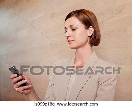 Stock Photography - Mid adult woman texting, portrait. Fotosearch