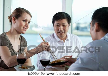 Multi racial businesspeople eating meal View Large Photo Image Stock Image - Multi racial businesspeople eating meal. Fotosearch