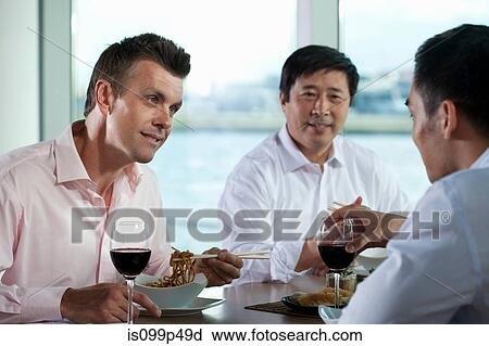 Multi racial businesspeople eating meal View Large Photo Image Stock Image - Multi racial businesspeople eating meal. Fotosearch