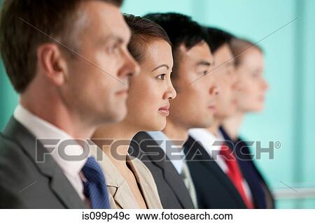 Stock Image - Multi racial businesspeople in a line, portrait. Fotosearch