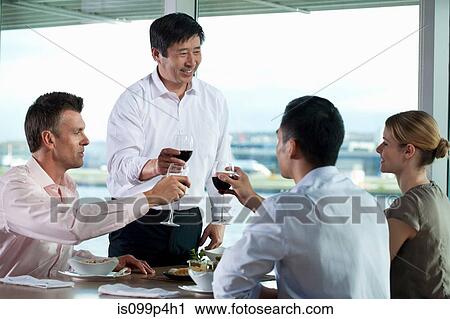 Stock Image - Multi racial businesspeople toasting wine. Fotosearch