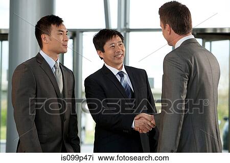 Multiracial businessmen shaking hands View Large Photo Image Stock Image - Multiracial businessmen shaking hands. Fotosearch