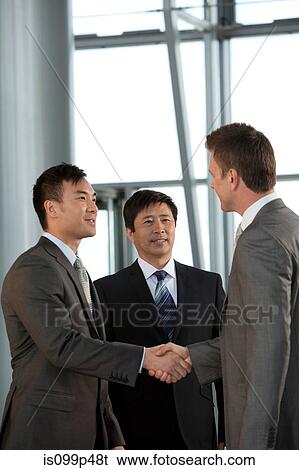 Multiracial businessmen shaking hands View Large Photo Image Stock Photograph - Multiracial businessmen shaking hands. Fotosearch