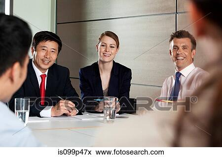 Stock Photo - Multiracial businesspeople in meeting. Fotosearch