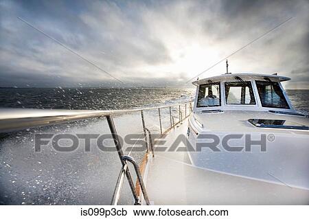 Stock Image - Power boat and ocean spray. Fotosearch