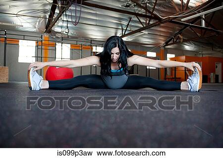 Pregnant young woman stretching to touch toes View Large Photo Image Stock Photo - Pregnant young woman stretching to touch toes. Fotosearch