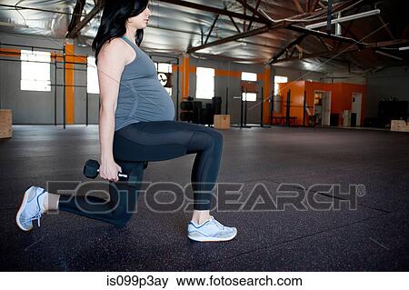 Pregnant young woman with hand weights View Large Photo Image Stock Photo - Pregnant young woman with hand weights. Fotosearch