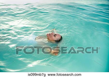 Relaxed woman floating in ocean View Large Photo Image Stock Image - Relaxed woman floating in ocean. Fotosearch