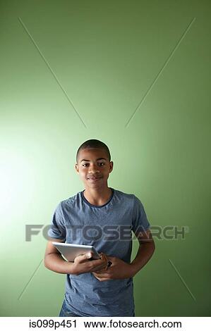 Stock Image - Schoolboy with digital tablet. Fotosearch