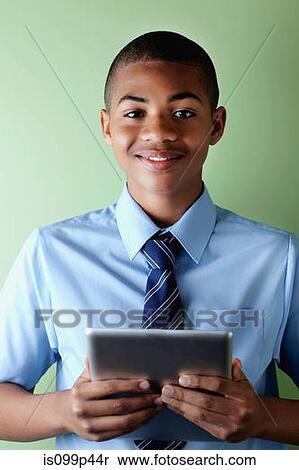 Schoolboy with digital tablet View Large Photo Image Stock Photography - Schoolboy with digital tablet. Fotosearch
