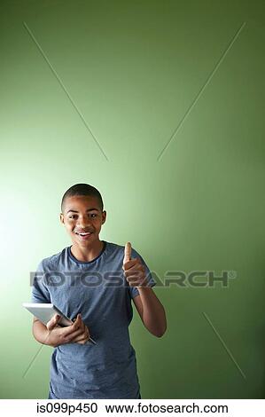 Schoolboy with thumb up and digital tablet View Large Photo Image Stock Image - Schoolboy with thumb up and digital tablet. Fotosearch
