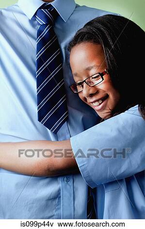 Schoolgirl hugging brother View Large Photo Image Stock Photo - Schoolgirl hugging brother. Fotosearch