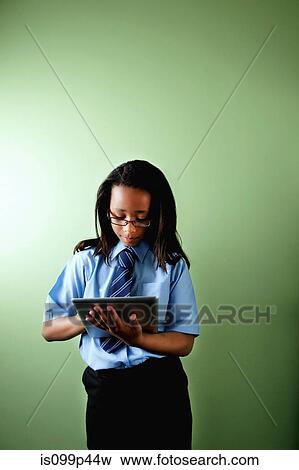 Schoolgirl using digital tablet View Large Photo Image Stock Photo - Schoolgirl using digital tablet. Fotosearch