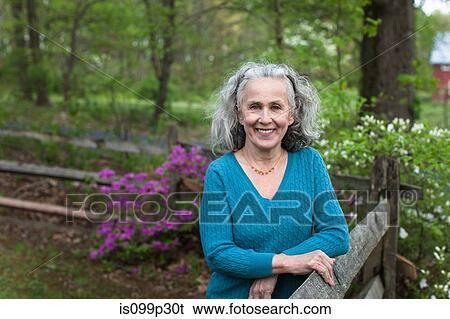 Senior woman in garden View Large Photo Image Stock Photograph - Senior woman in garden. Fotosearch