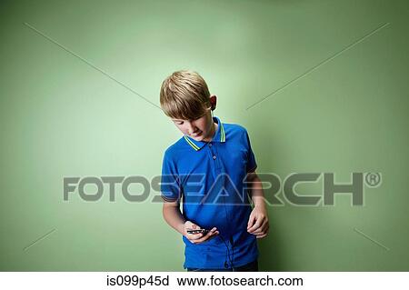 Stock Image - Teenage boy listening to mp3 player. Fotosearch
