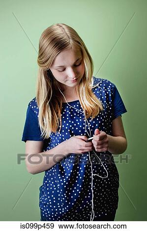 Teenage girl listening to mp3 player View Large Photo Image Stock Photo - Teenage girl listening to mp3 player. Fotosearch