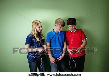 Stock Image - Three friends with mp3 players. Fotosearch