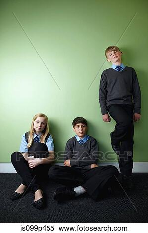 Stock Photography - Three surly school children looking at camera. Fotosearch