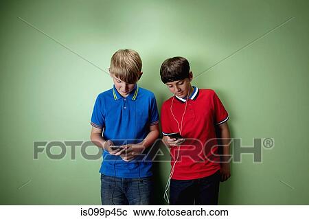 Stock Image - Two boys with mp3 players. Fotosearch
