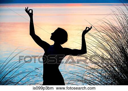 Picture - Woman performing dance at sunset. Fotosearch