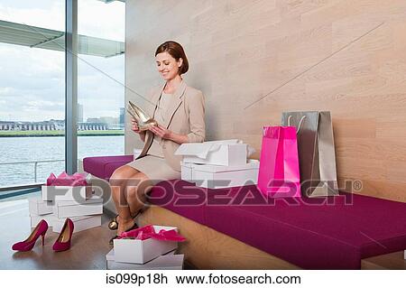 Woman trying on shoes in shoe shop View Large Photo Image Stock Image - Woman trying on shoes in shoe shop. Fotosearch