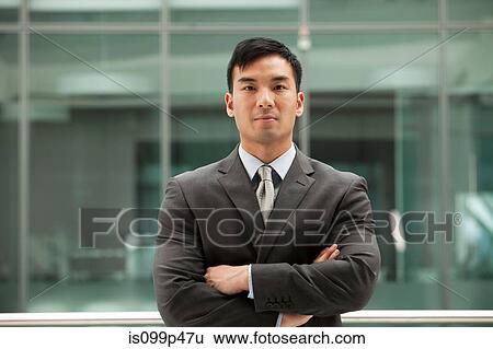 Young businessman looking at camera, portrait View Large Photo Image Stock Photograph - Young businessman looking at camera, portrait. Fotosearch