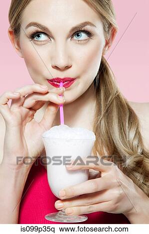 Young woman drinking milk shake View Large Photo Image Stock Photography - Young woman drinking milk shake. Fotosearch