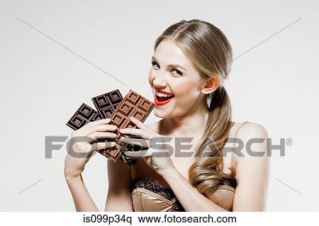 Young woman holding chocolate View Large Photo Image Stock Photography - Young woman holding chocolate. Fotosearch