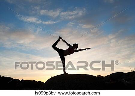 Stock Photo - Young woman in dancer pose in desert, silhouette. Fotosearch