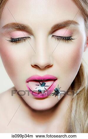 Young woman with plastic fly on tongue View Large Photo Image Picture - Young woman with plastic fly on tongue. Fotosearch