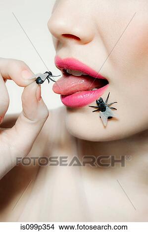 Young woman with plastic fly on tongue View Large Photo Image Picture - Young woman with plastic fly on tongue. Fotosearch