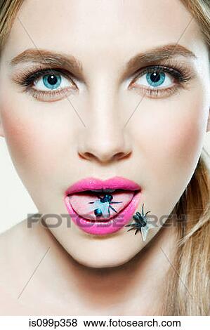 Young woman with plastic fly on tongue View Large Photo Image Stock Photo - Young woman with plastic fly on tongue. Fotosearch