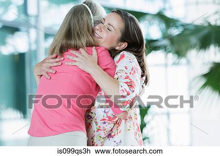 Adult mother and daughter embracing View Large Photo Image Stock Image - Adult mother and daughter embracing. Fotosearch
