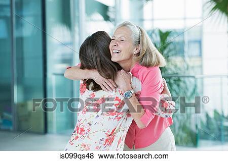 Stock Photo - Adult mother and daughter embracing. Fotosearch