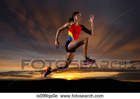 Athlete in mid air against sunset View Large Photo Image Stock Image - Athlete in mid air against sunset. Fotosearch