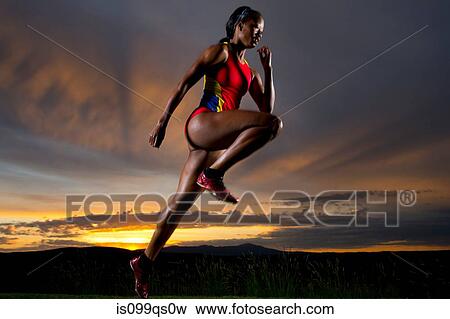 Athlete in mid air against sunset View Large Photo Image Stock Photo - Athlete in mid air against sunset. Fotosearch