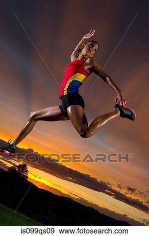 Athlete jumping against sunset View Large Photo Image Stock Photo - Athlete jumping against sunset. Fotosearch
