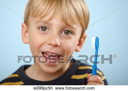 Boy holding toothbrush View Large Photo Image Stock Image - Boy holding toothbrush. Fotosearch