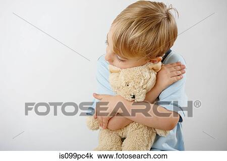 Boy hugging teddy View Large Photo Image Stock Image - Boy hugging teddy. Fotosearch