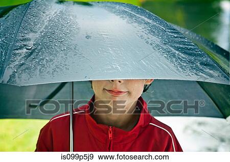 Stock Photo - Boy under an umbrella. Fotosearch
