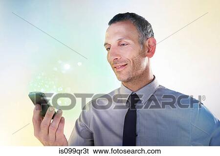 Businessman holding cellphone with lights View Large Photo Image Stock Photograph - Businessman holding cellphone with lights. Fotosearch
