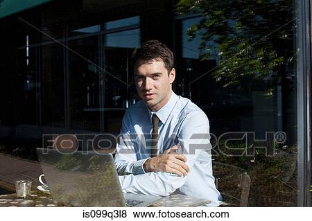Stock Photo - Businessman in cafe, view through window. Fotosearch