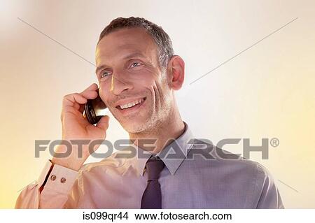 Picture - Businessman using cellphone. Fotosearch