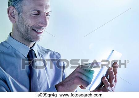 Businessman using digital tablet with lights View Large Photo Image Stock Image - Businessman using digital tablet with lights. Fotosearch