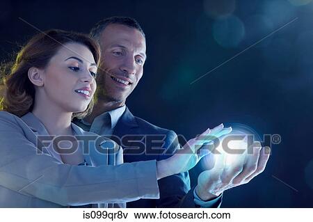 Businesspeople holding light View Large Photo Image Stock Photo - Businesspeople holding light. Fotosearch