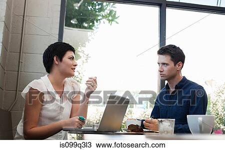 Businesspeople in cafe with laptop View Large Photo Image Stock Image - Businesspeople in cafe with laptop. Fotosearch