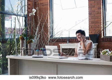 Businesswoman at desk on the phone View Large Photo Image Picture - Businesswoman at desk on the phone. Fotosearch